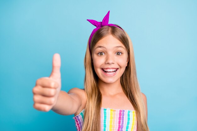 Portrait of positive cheerful excited girl show thumb up sign