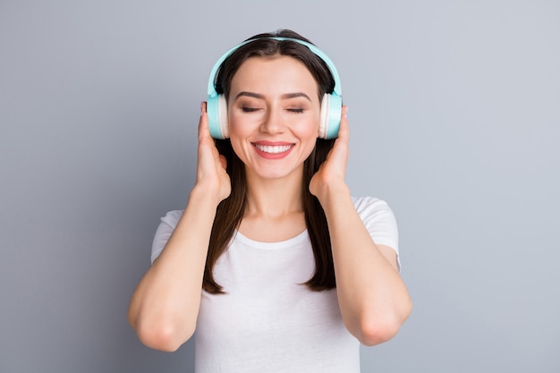 Portrait of positive cheerful girl hold wireless listen disco music