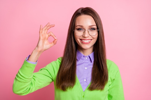 Portrait of positive cheerful girl show okay sign  isolated over pastel color background