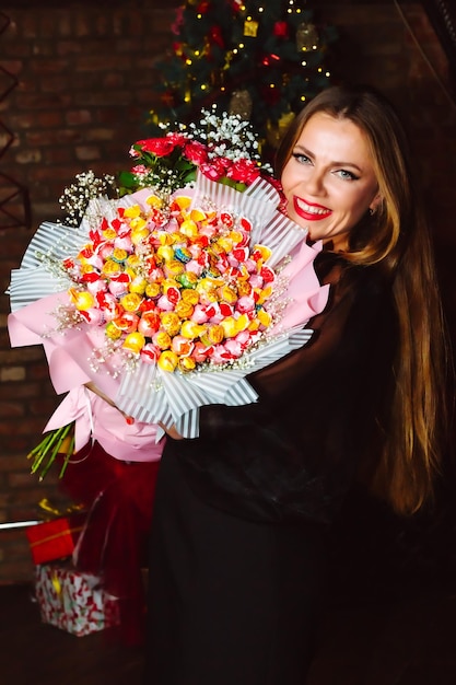 Portrait of a positive girl with a big bouquet of chupachups A smiling woman with chupachups is posing