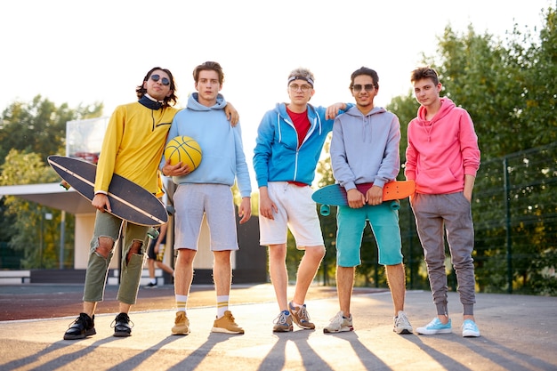 Portrait of positive group of young people came to play basketball