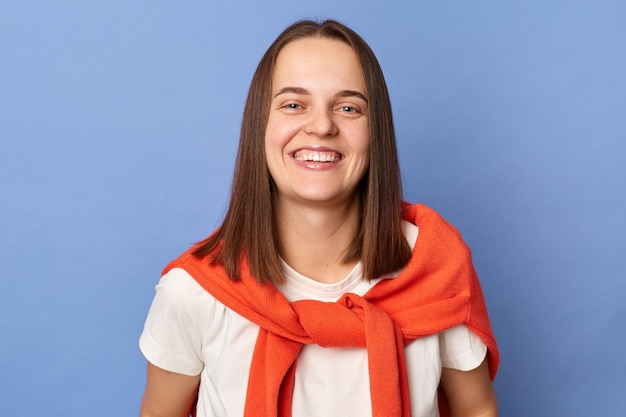 Portrait of positive happy optimistic woman wearing casual style clothing looking at camera with toothy smile being in good mood standing isolated over blue background