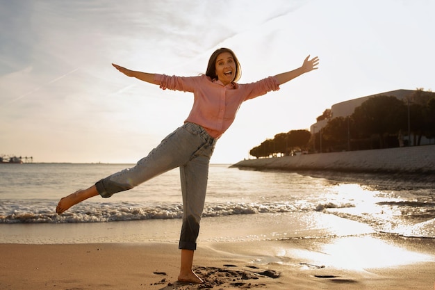 Portrait of positive middle aged woman having fun at the beach