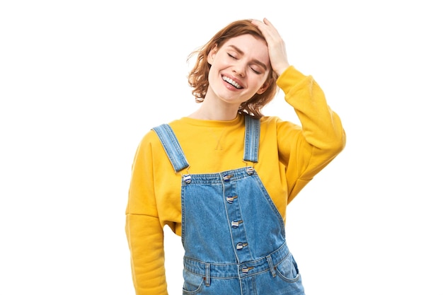 Portrait of positive redhead girl in casual jeans emotionally rejoices and feels happy isolated on white background advertising banner