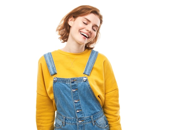 Portrait of positive redhead girl in casual jeans emotionally rejoices and feels happy isolated on white background advertising banner