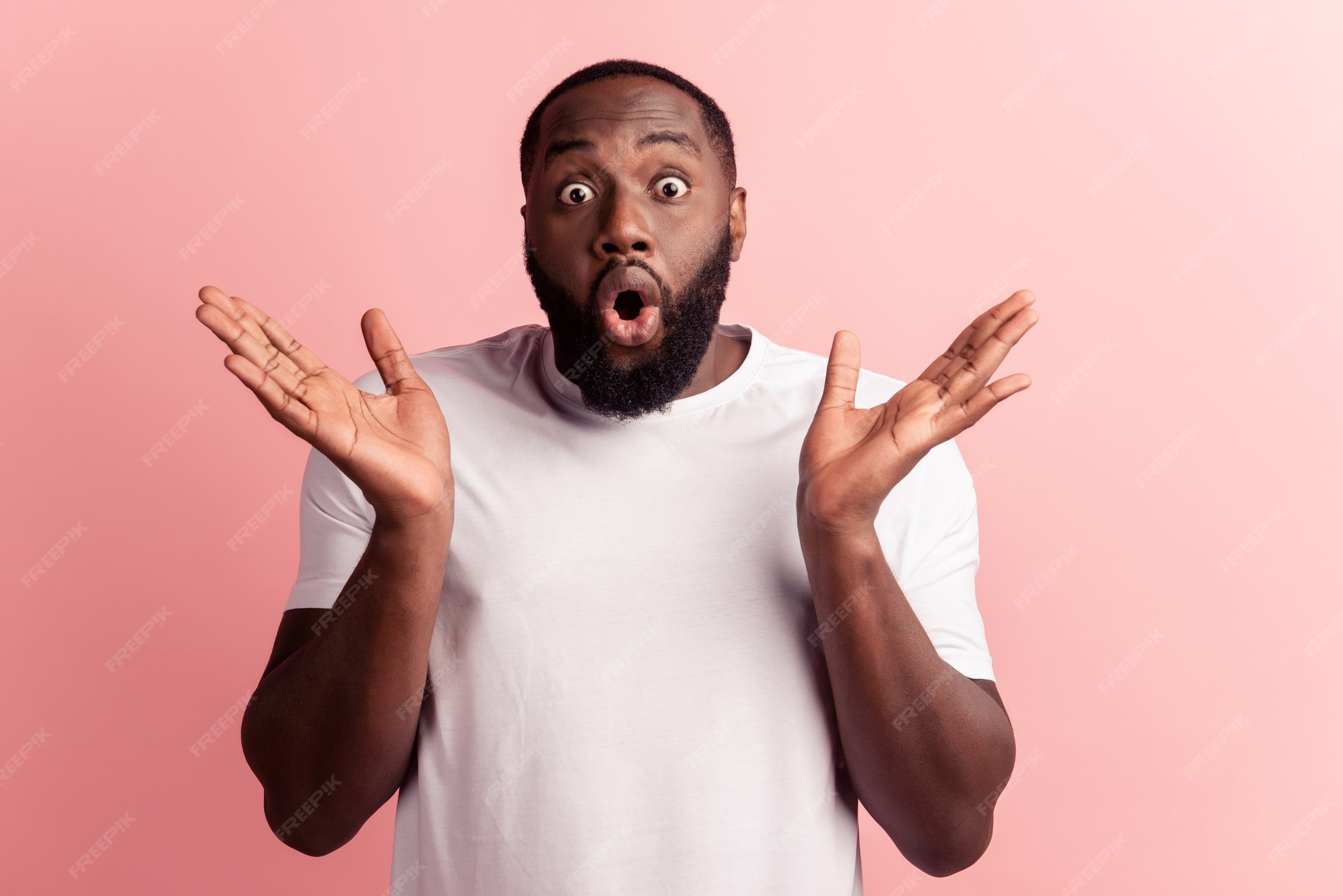 Premium Photo | Portrait of positive shocked man excited face raise palms  open mouth on pink background