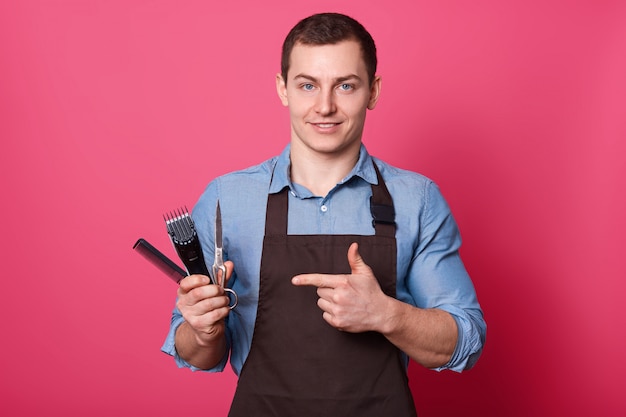 Portrait of positive smiling hairdresser