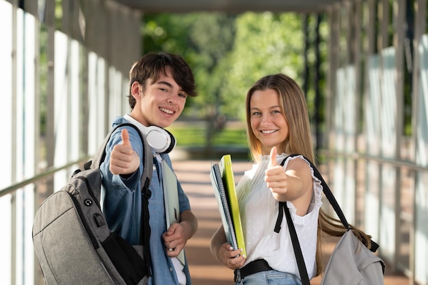 Portrait of positive students making ok sign