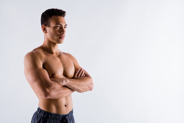 Portrait of powerful strong content tanned guy world champion folded arms