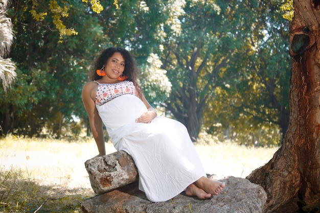 Portrait of a pregnant afro hair woman in the city