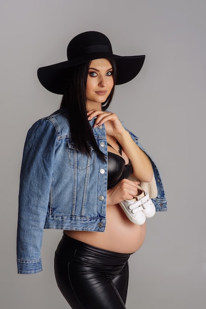 portrait of pregnant brunette in hat