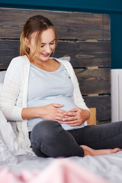 Foto il ritratto di una donna incinta è pieno di aspettative per il bambino