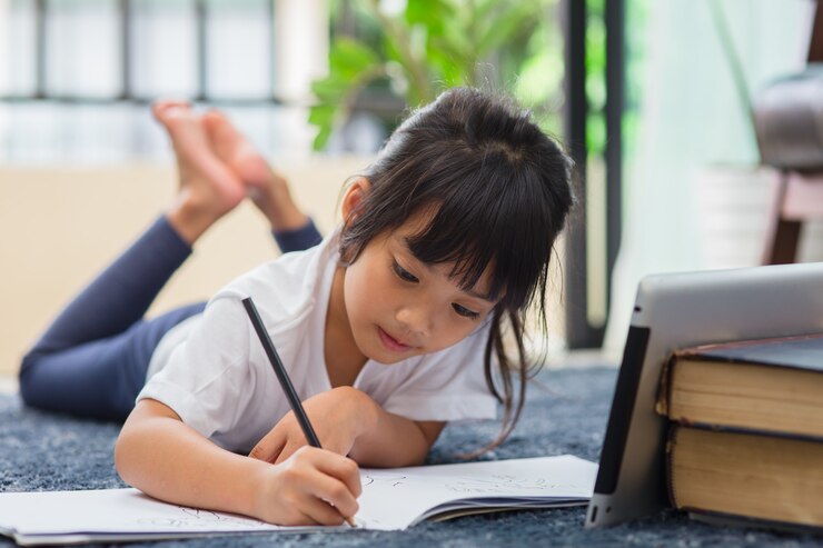Photo 宿題にタブレットを使用している就学前の子供の肖像画、インターネット上のデジタルタブレット検索情報を使用して宿題をしている子供のソフトフォーカス、eラーニングまたはホームスクーリング教育の概念