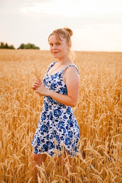 Portrait of pretty 15yearold girl walking in cereal field