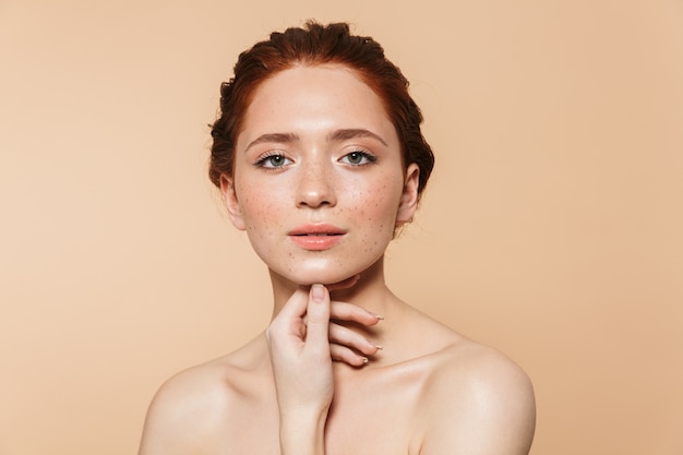 Portrait of a pretty amazing young redhead woman posing isolated.