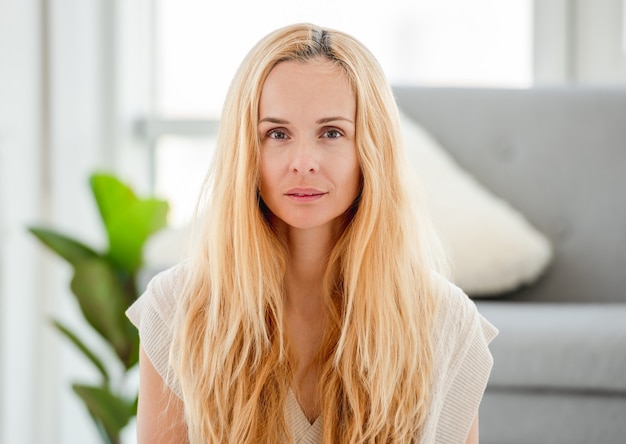 Portrait of pretty attractive blond girl without makeup at home