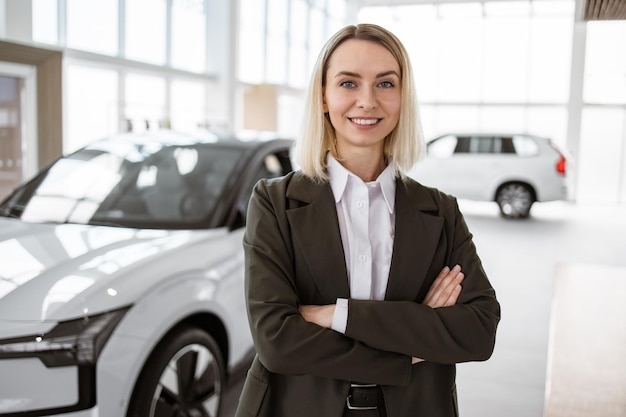 Portrait of pretty caucasian vehicle saleswoman in suit