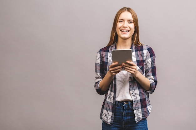 Portrait  of pretty charming confident smiling woman in casual having tablet in hands