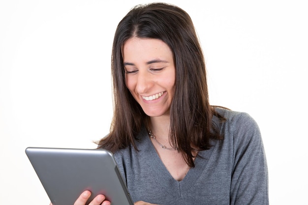 Portrait of pretty charming confident trendy woman with computer tablet in hands isolated on white background