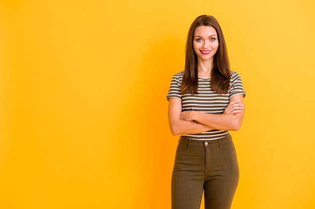 Portrait of pretty confident girl worker stand copyspace ready work cross hands wear good looking outfit isolated over yellow color wall