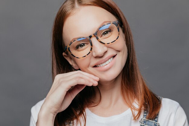 Portrait of pretty female model smiles gently