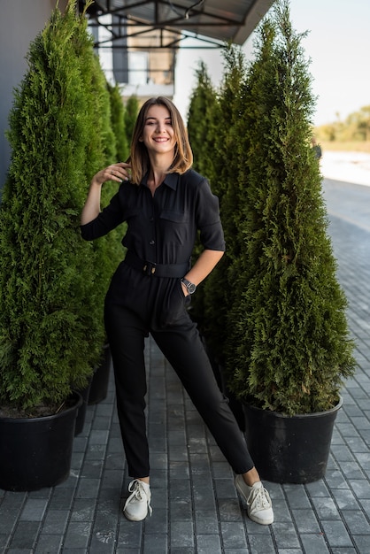 Portrait of a pretty girl between evergreen trees. lifestyle