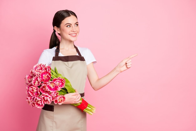 Portrait of pretty girl holding in hands bouquet showing copy space ad