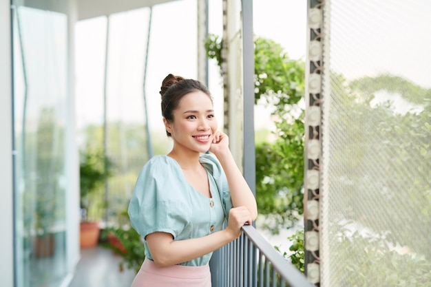 Portrait pretty girl looking the view on balcony Relaxation