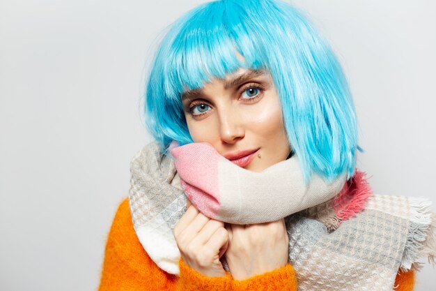 Portrait of pretty girl with blue hair wearing scarf 