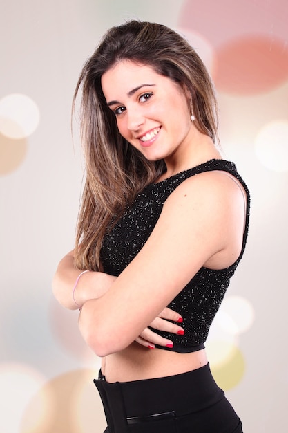 portrait of a pretty girl with long straight hair in profile smiling with crossed arms