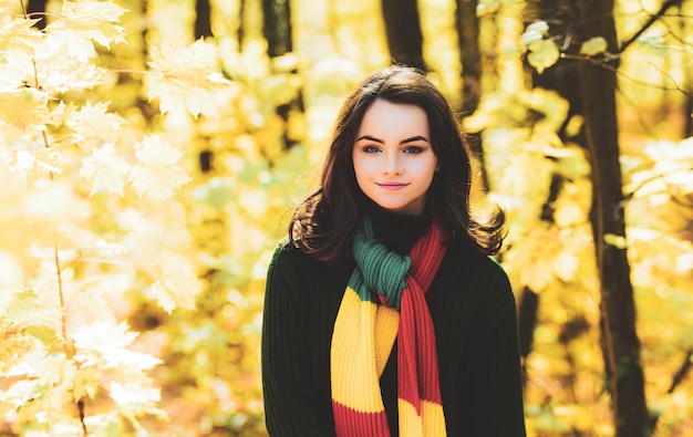 Portrait of pretty nice teenage girl in autumn park