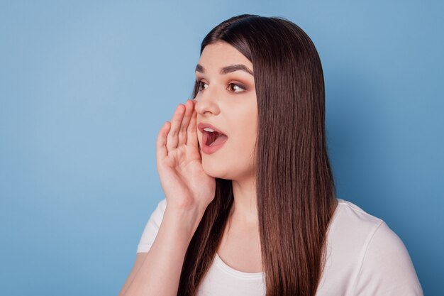 Portrait of pretty promoter gossip lady palm open mouth look empty space share recent news on blue background