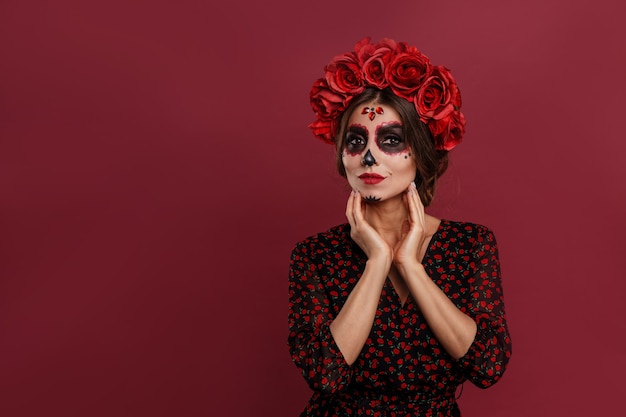 portrait of pretty scary woman posing in mexican attire in day of the dead