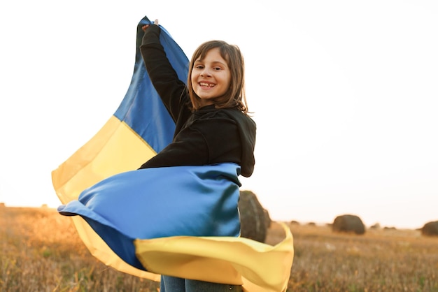 Portrait of pretty slim girl with yellowblue flag of ukraine in field lifestyle love ukraine concept