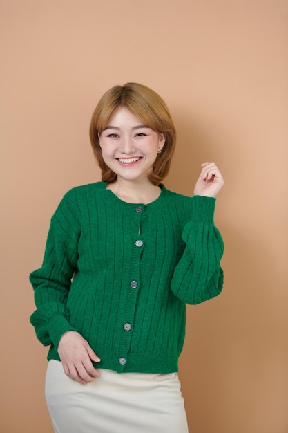 Portrait of a pretty smiling woman posing isolated on a beige background