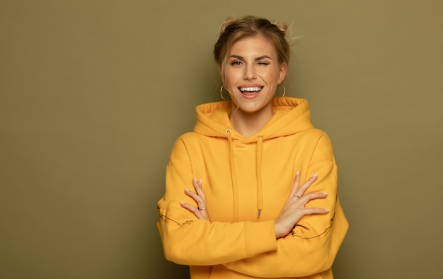 Portrait of a pretty smiling woman posing isolated on a color background