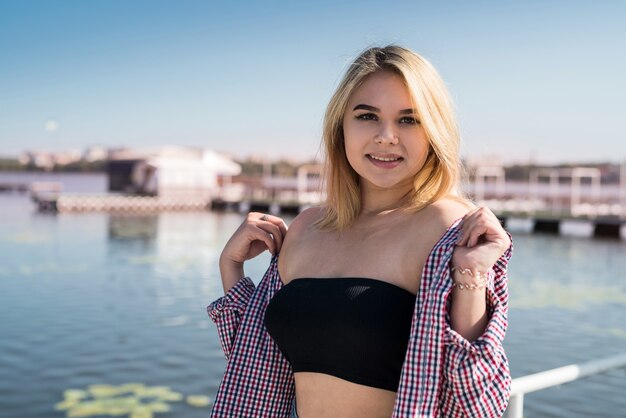 Portrait of pretty teenage girl in near a city pond, summer time, vacation