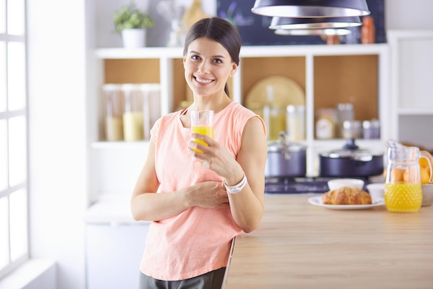 Portrait of a pretty woman holding glass with tasty juice