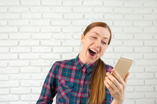 Portrait of a pretty woman holding a smartphone