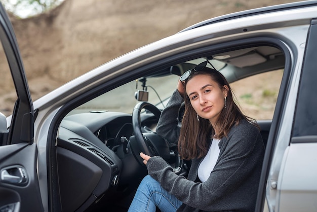 Portrait of pretty woman inside car