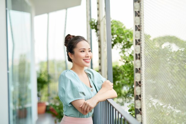 Portrait pretty woman looking the view on balcony