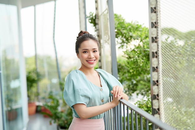 Portrait pretty woman looking the view on balcony