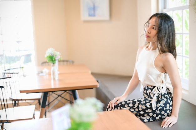 PORTRAIT Pretty woman in a restaurant cafe with feeling happy