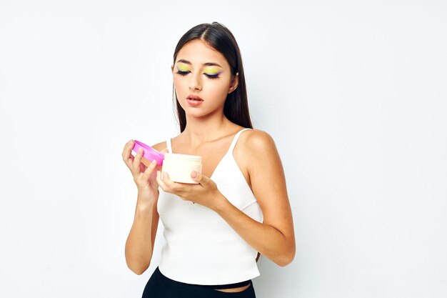 Portrait pretty woman in a white jersey jar with cosmetics studio model unaltered