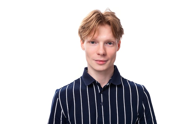 Portrait of a pretty young blond guy in a striped polo shirt on a white background