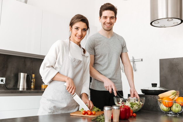 Portrait of a pretty young couple cooking together