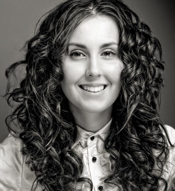 Portrait of pretty young woman with curly hair Sepia tone