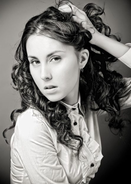 Portrait of pretty young woman with curly hair