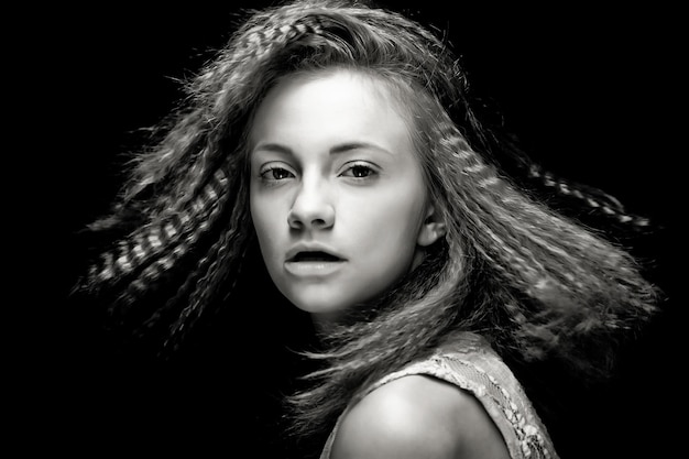 Portrait of pretty young woman with curly hair