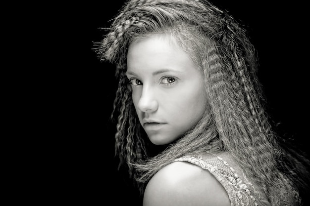 Portrait of pretty young woman with curly hair